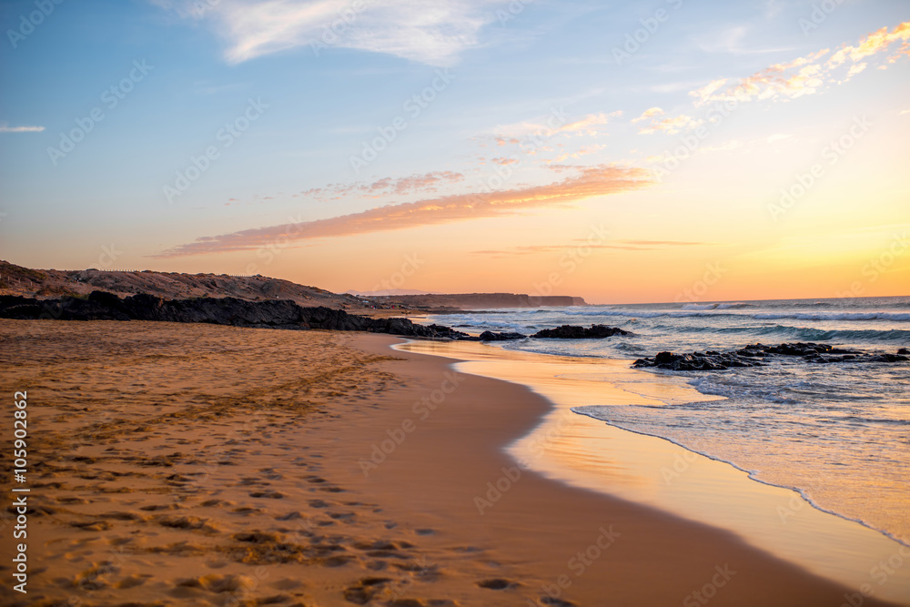 Beautiful sand beach near El Cotillo village on Fuerteventura island on the sunset in Spain