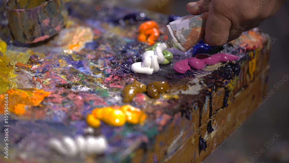 Squeezed out on a palette oil picturesque colors from an open tube Squeezed out on a palette oil picturesque colors from an open tube