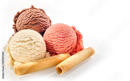 Three scoops of ice cream with wafer rolls photo