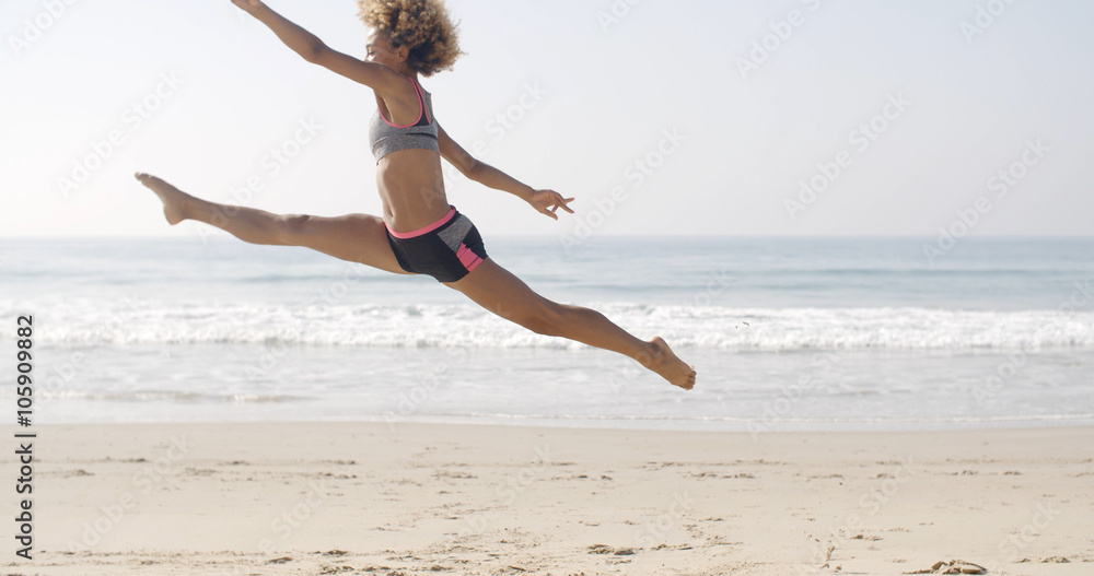 Woman jumping on the sand of the beach with sea on the background in slow motion, Woman jumping on the sand of the beach with sea on the background in slow motion,