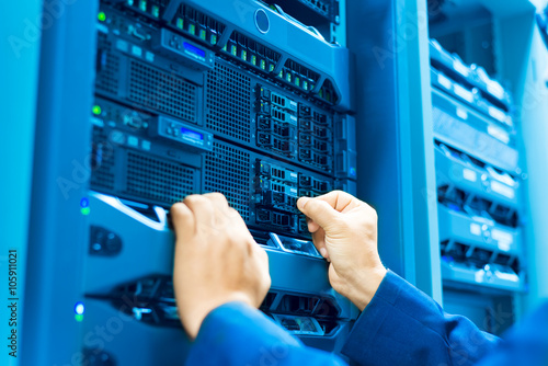 Man fix server network in data center room photo