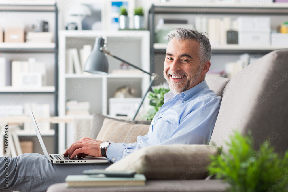 Cheerful businessman working at home