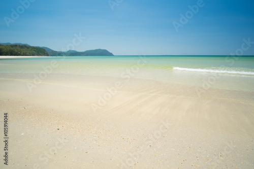 Sea and sand on the beach in blue sky.