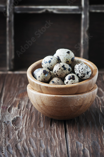 Raw quail eggs on the wooden table