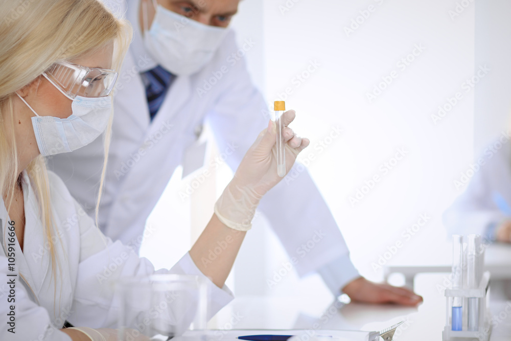 Scientific research team with clear solution in laboratory Scientific research team with clear solution in laboratory