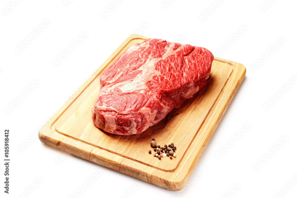 marble veal steak on a board on a white background