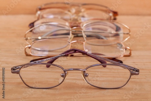 Closeup of glasses with many eyeglasses in background