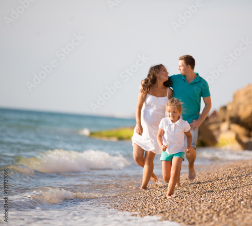 pregnant woman and her family near the sea