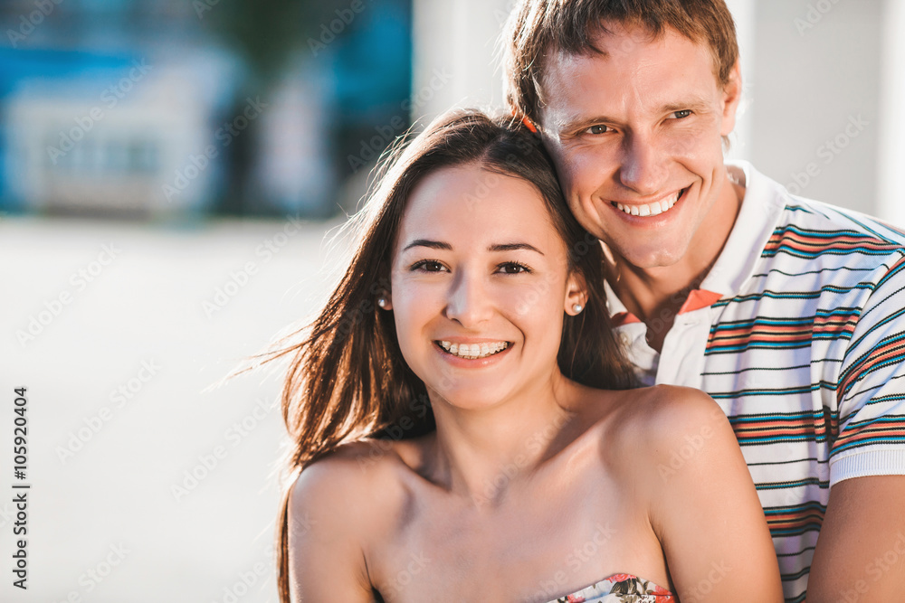 The guy embraces his girlfriend during a walk in the fresh air The guy embraces his girlfriend during a walk in the fresh air