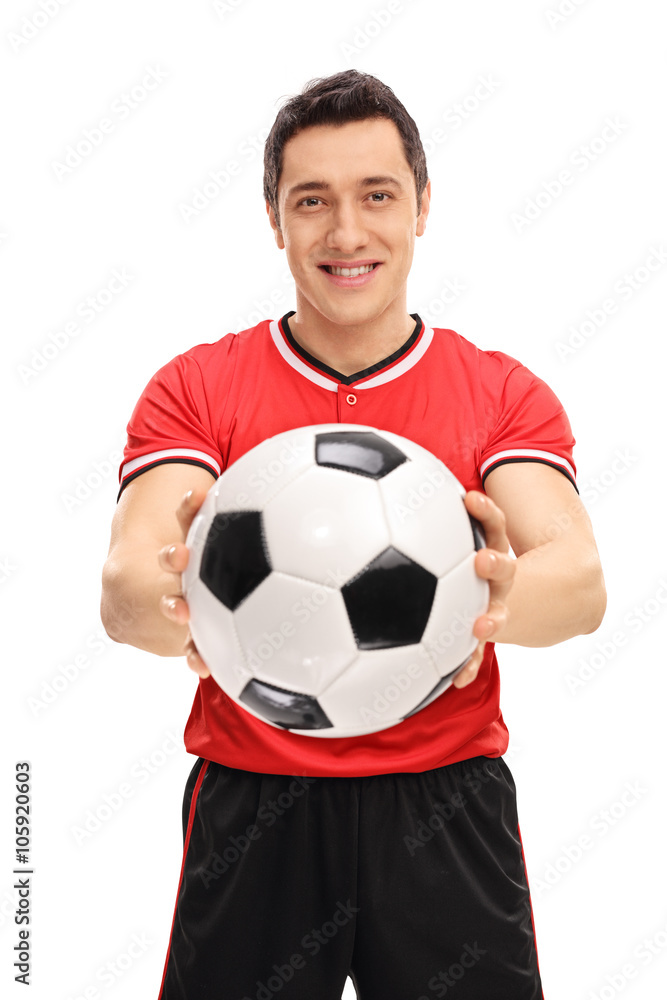 Young football player holding a ball Young football player holding a ball