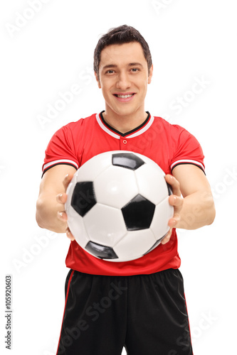 Young football player holding a ball