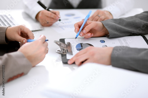 Group of business people at the meeting discussing financial results