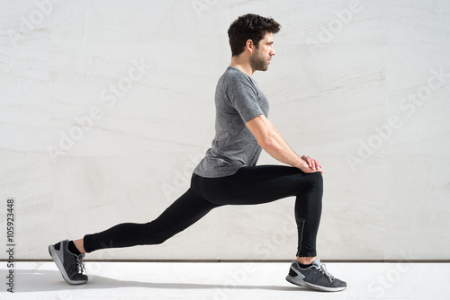 Fotografie Man stretching quadriceps