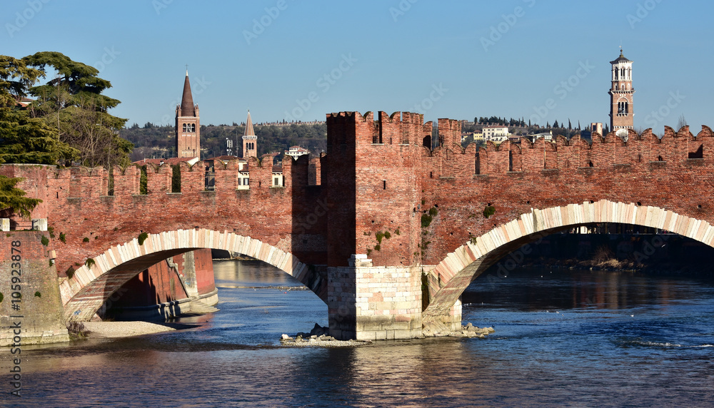 Naklejka premium Scaliger Bridge in Verona with Tower of Lamberti, the city tallest tower, and belfries of St Anastasia and Eufemia