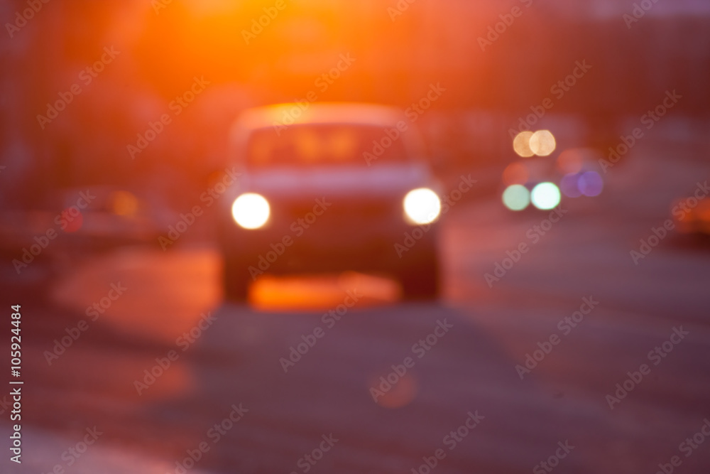 Blurred silhuette of a car at sunset