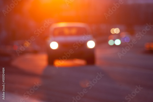 Blurred silhuette of a car at sunset © yo camon