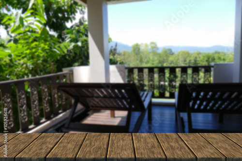 wooden deckchair at the balcony with forest and sky view © 88studio