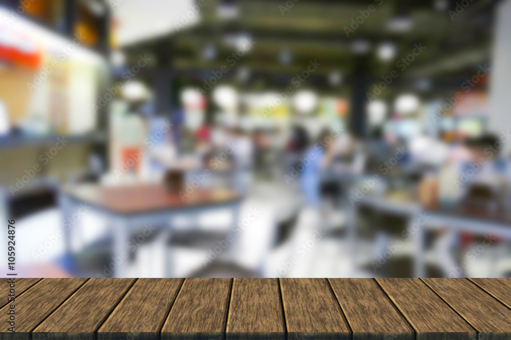 blurry defocused image of people eating food in food court
