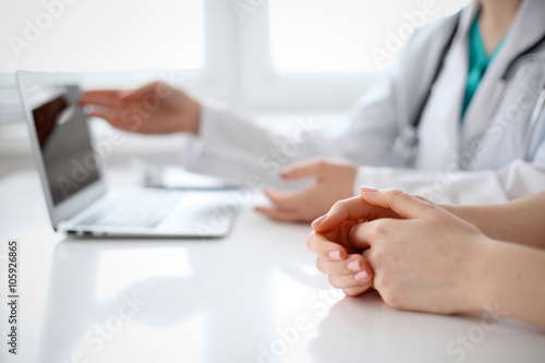 Doctor and patient are discussing something, just hands at the table