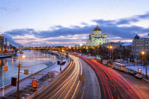Light tracks of cars in Prechistenskaya waterfront on the background of Christ the Savior