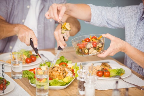 Midsection of family having meal