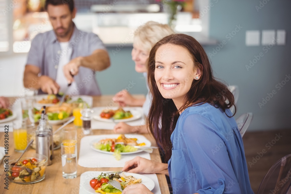 Happy woman having breakfast with family
