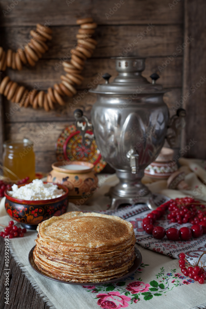 Traditional Ukrainian pancakes with cottage cheese and milk on vintage wooden table background