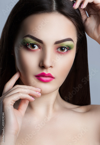fashion portrait of a young beautiful girl with bright makeup.