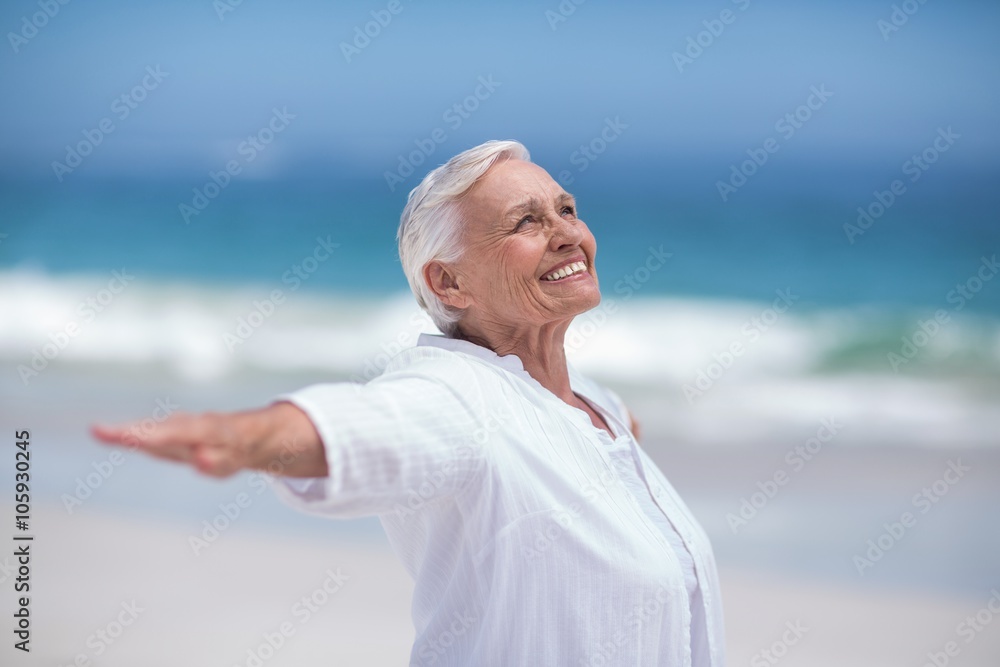 Side view of mature woman posing with outstretched arms