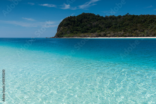 Beach on the tropical island with green water © sorapop