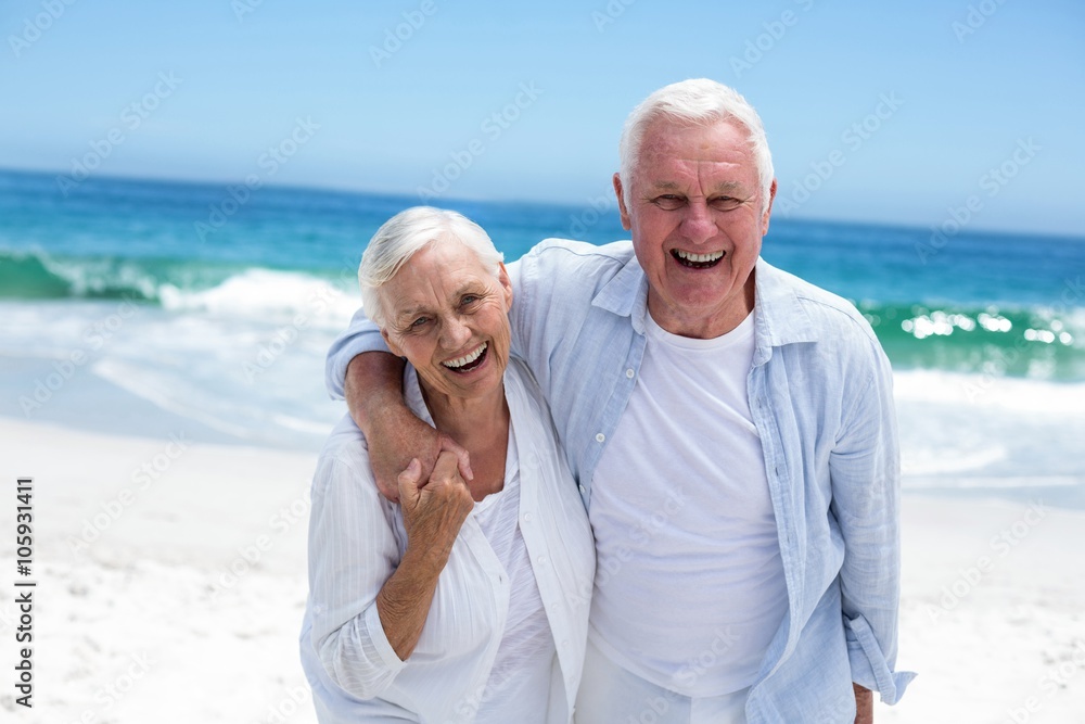 Senior couple embracing and looking the camera