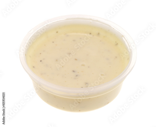 Container of ranch dressing on a white background