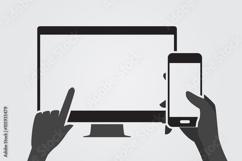 Modern computer screen and hand using smartphone.