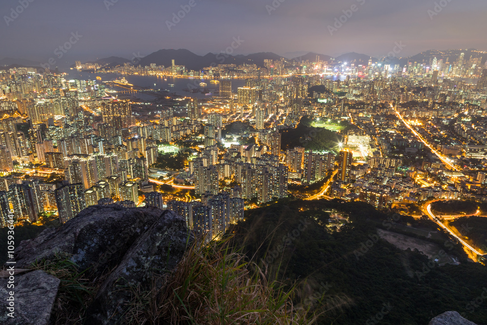 View of New Kowloon and Kowloon in Hong Kong from above from the Lion Rock in Hong Kong, China, at night.
