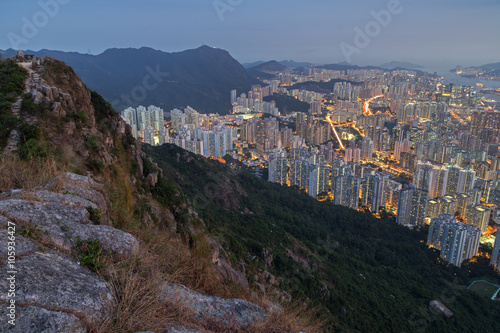 View of hills and New Kowloon in Hong Kong from above from the Lion Rock in Hong Kong, China, at dusk. © tuomaslehtinen