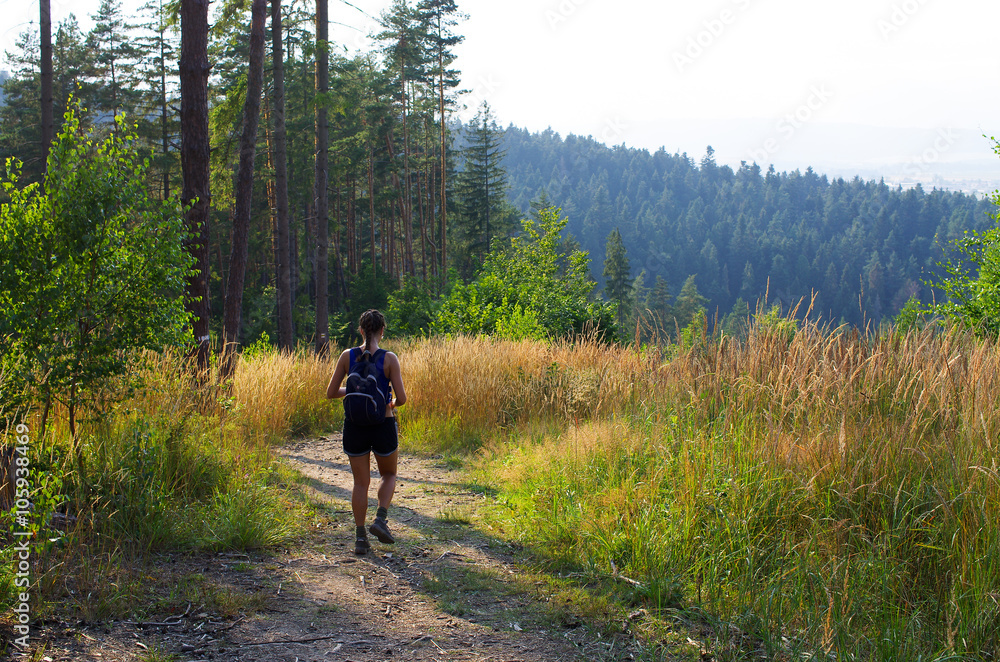 Fototapeta premium Young woman hiking in the hills