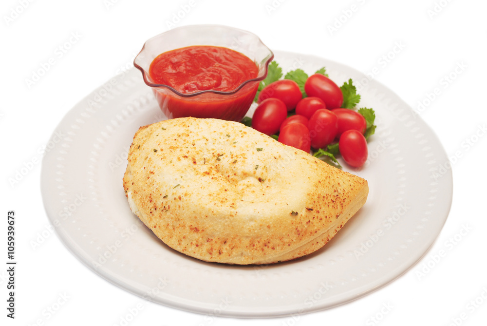 Plated Calzone with Tomato Dipping Sauce & Fresh Tomamtoes Plated Calzone with Tomato Dipping Sauce & Fresh Tomamtoes