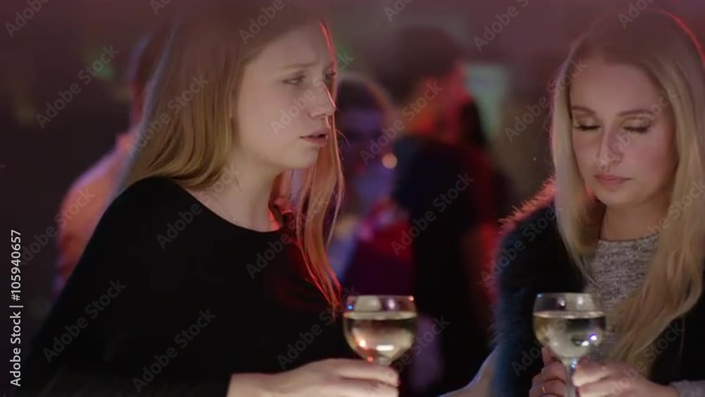 sad girl at bar in club is comforted by a friend sad girl at bar in club is comforted by a friend