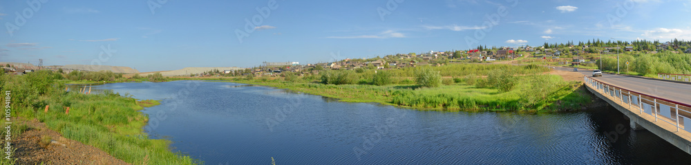 Rural area in the town of Mirny, Irelyakh bridge over the river.
