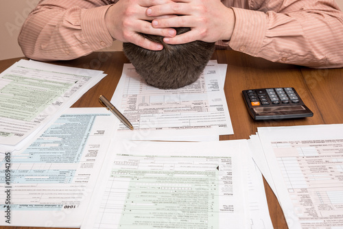 business man filling out usa 1040 tax form