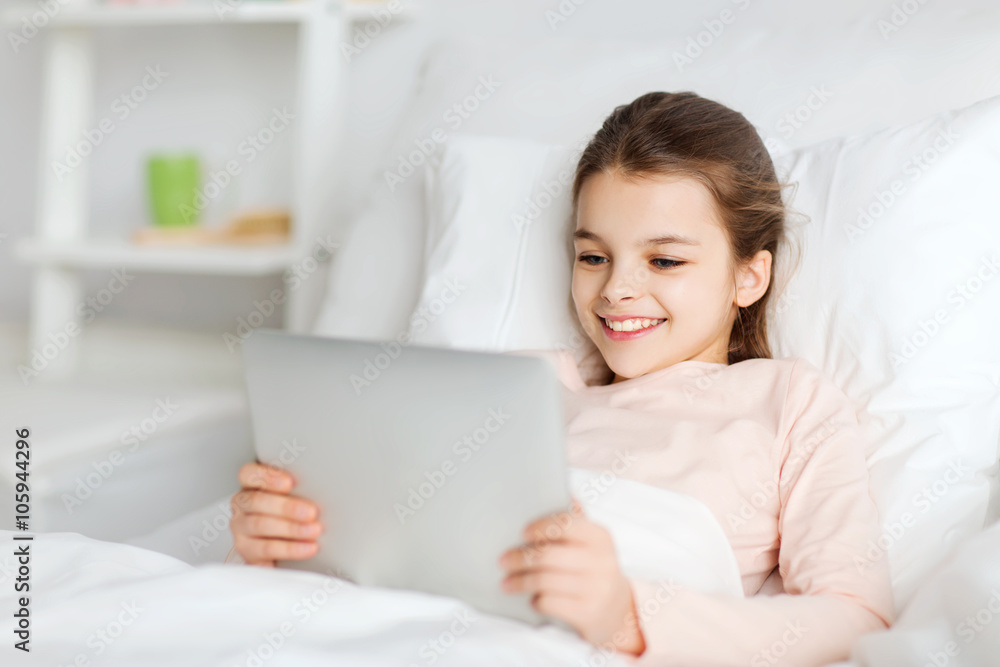 happy girl lying in bed with tablet pc at home happy girl lying in bed with tablet pc at home