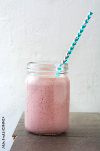 Strawberry smoothie on wooden 