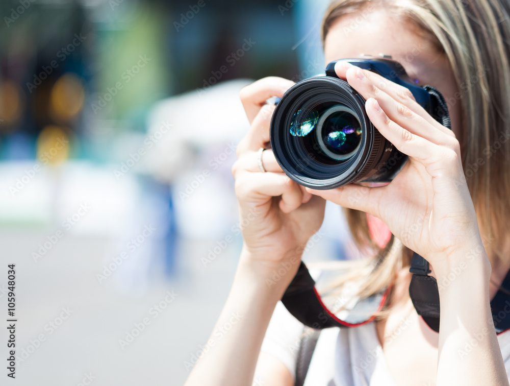 Female photographer using a digital camera