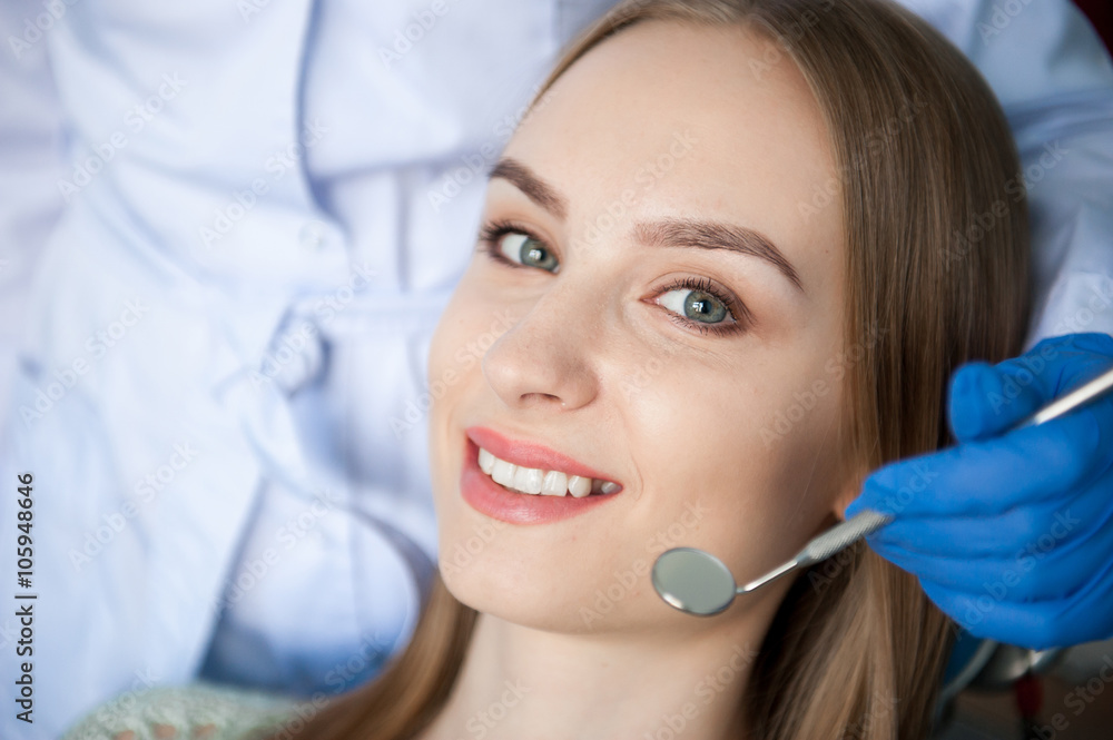 Dentist examining a patient's teeth Dentist examining a patient's teeth