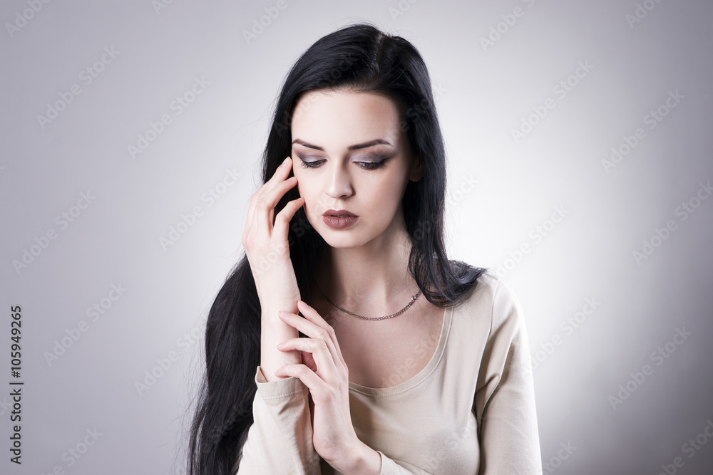 Beautiful woman portrait on a gray background. Professional makeup Beautiful woman portrait on a gray background. Professional makeup