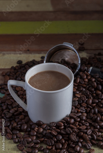 White coffee cup with beans background