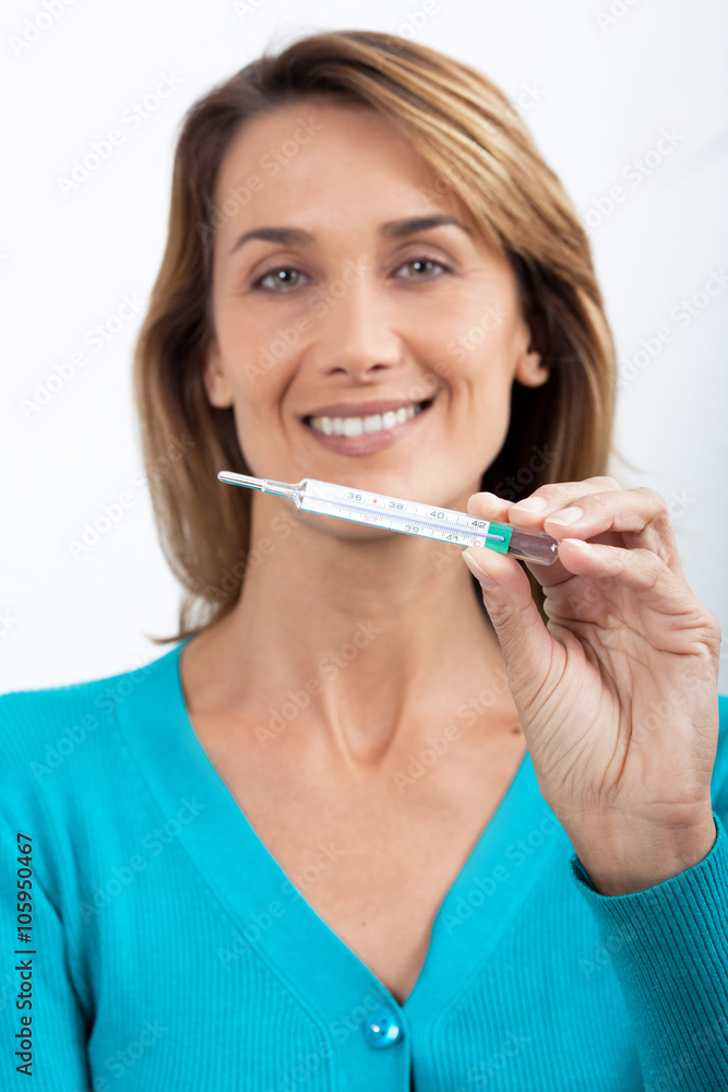 femme souriante guérie avec son thermomètre femme souriante guérie avec son thermomètre