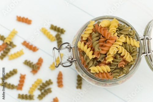 Raw fusilli pasta on a glass jar photo