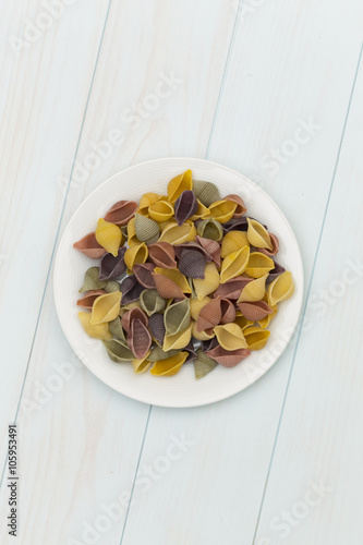 Raw cocciolette pasta in a white plate photo