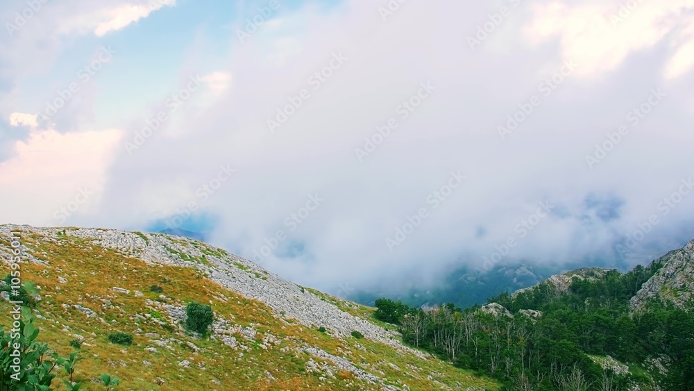 Cloudy weather view of the highest peaks of the Lovcen mountain national park in southwestern Montenegro, paning from the left to the right. Cloudy weather view of the highest peaks of the Lovcen mountain national park in southwestern Montenegro, paning from the left to the right.